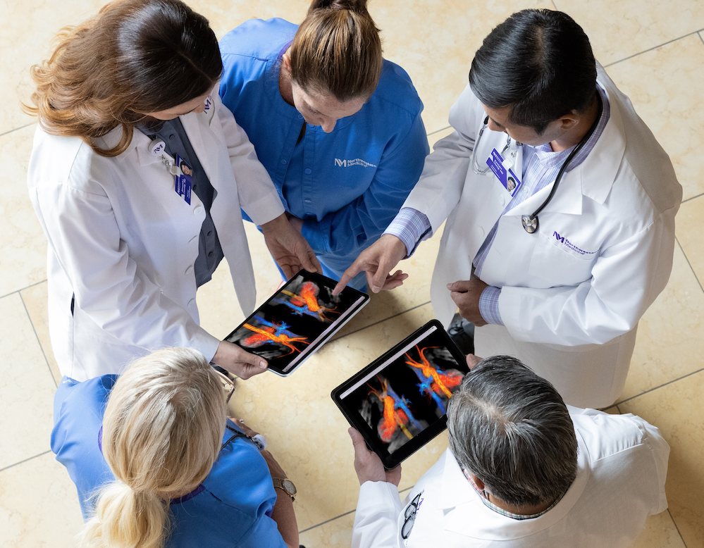 physicians looking at tablets showing an image