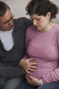 Couple holding woman's stomach