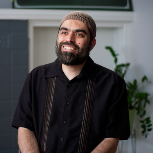Man in a black shirt talking about the Inner-City Muslim Action Network