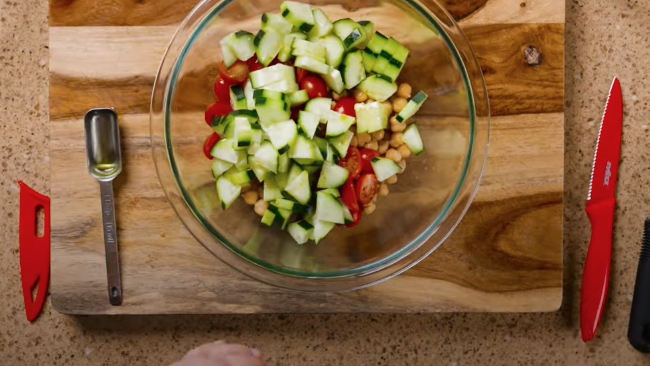 A salad made with cherry tomatoes, diced cucumbers and chickpeas.