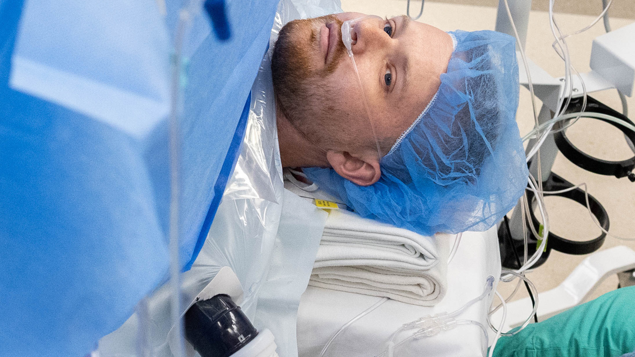 John Nicholas undergoing a kidney transplant surgery while awake with a surgical curtain separating him from the surgical team.