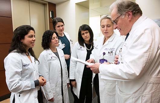 A team of Northwestern Medicine cancer physicians reviewing paperwork.