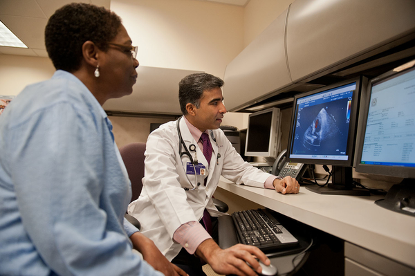 Two Northwestern Medicine providers look at computer with patient scans