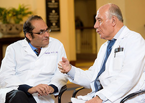 Two physicians with the Movement Disorders Centers of Excellence in discussion.