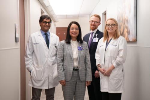 Four members of the Rare and Aggressive Brain Tumors clinical team standing in a hospital hallway