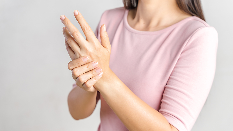 A person holding their wrist. 