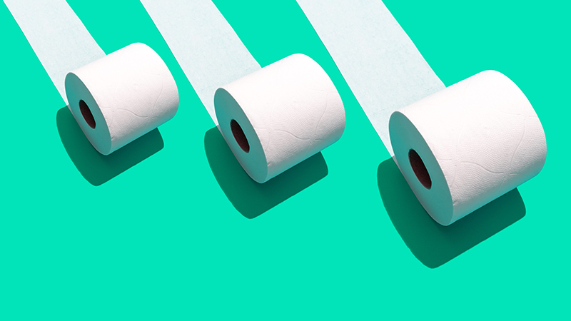 Illustration of three white toilet paper rolls on a green background.