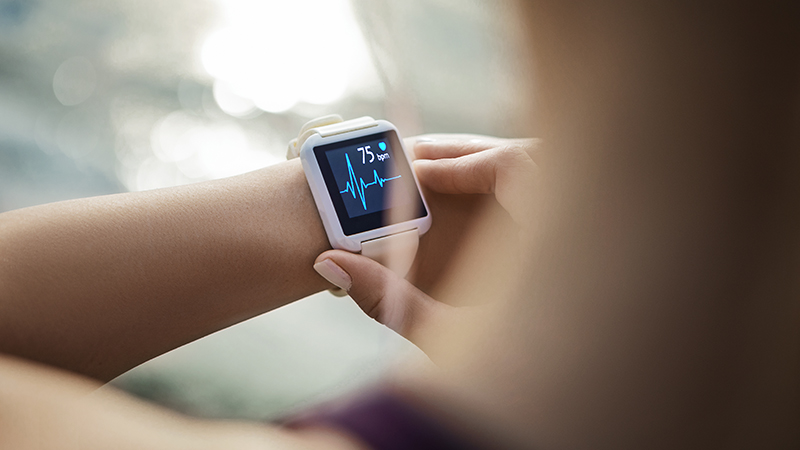 A person looking at their smartwatch for a pulse rate.